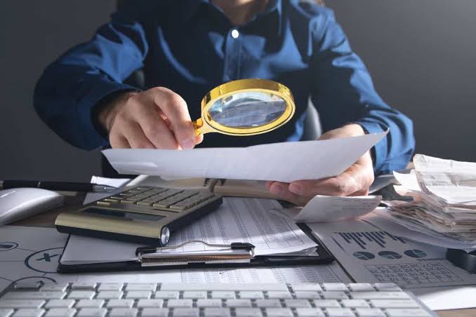 Auditor interno examinando evidências